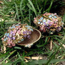 Load image into Gallery viewer, Enamel Easter egg boxes in gold. Forget me not flowers decorate the surface.